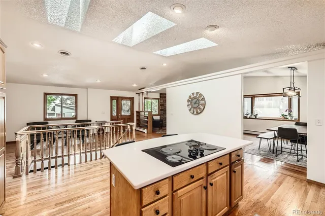 a kitchen with a stove and wooden floor