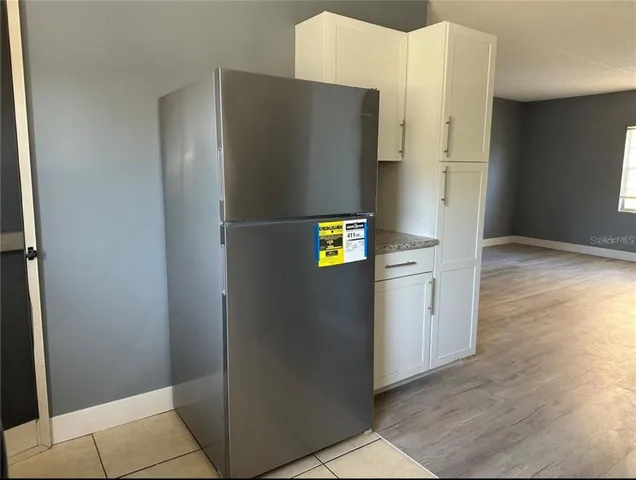 a kitchen with metallic refrigerator and counter