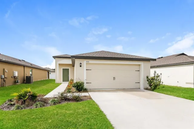 a view of a house with a yard and garage