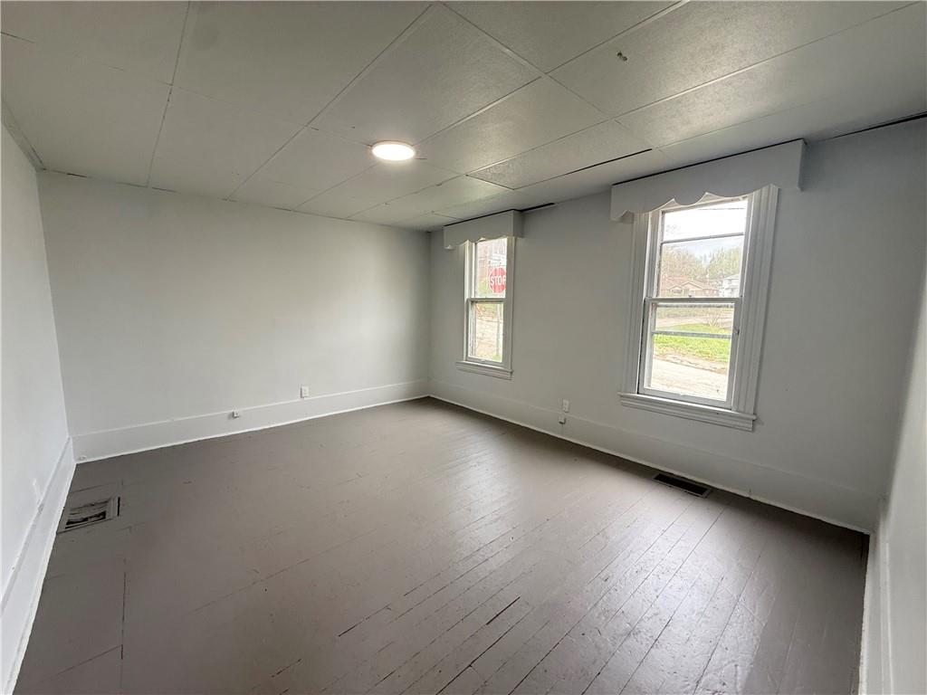 307 Andrew Street Sharon, PA 16146 - Photo 2 of 7 an empty room with wooden floor and windows