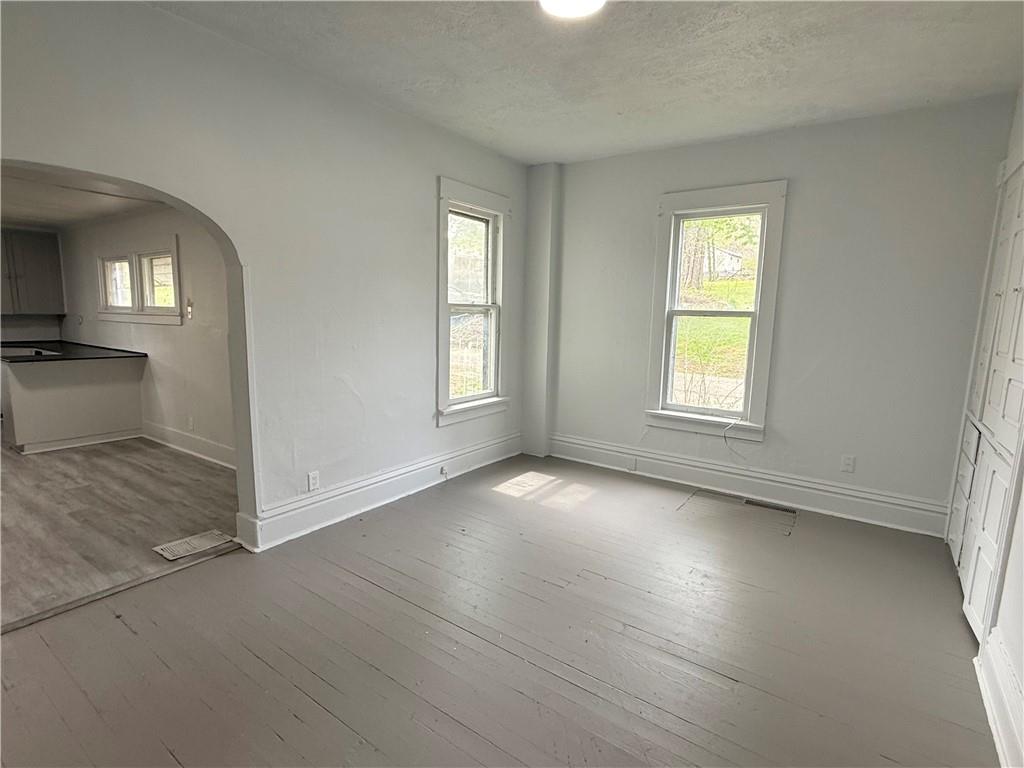 307 Andrew Street Sharon, PA 16146 - Photo 3 of 7 wooden floor in an empty room with a window