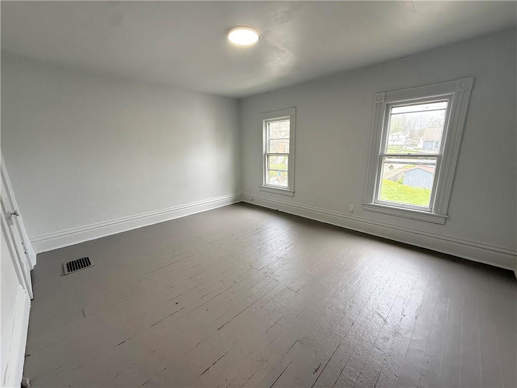 307 Andrew Street Sharon, PA 16146 - Photo 6 of 7 an empty room with wooden floor and windows