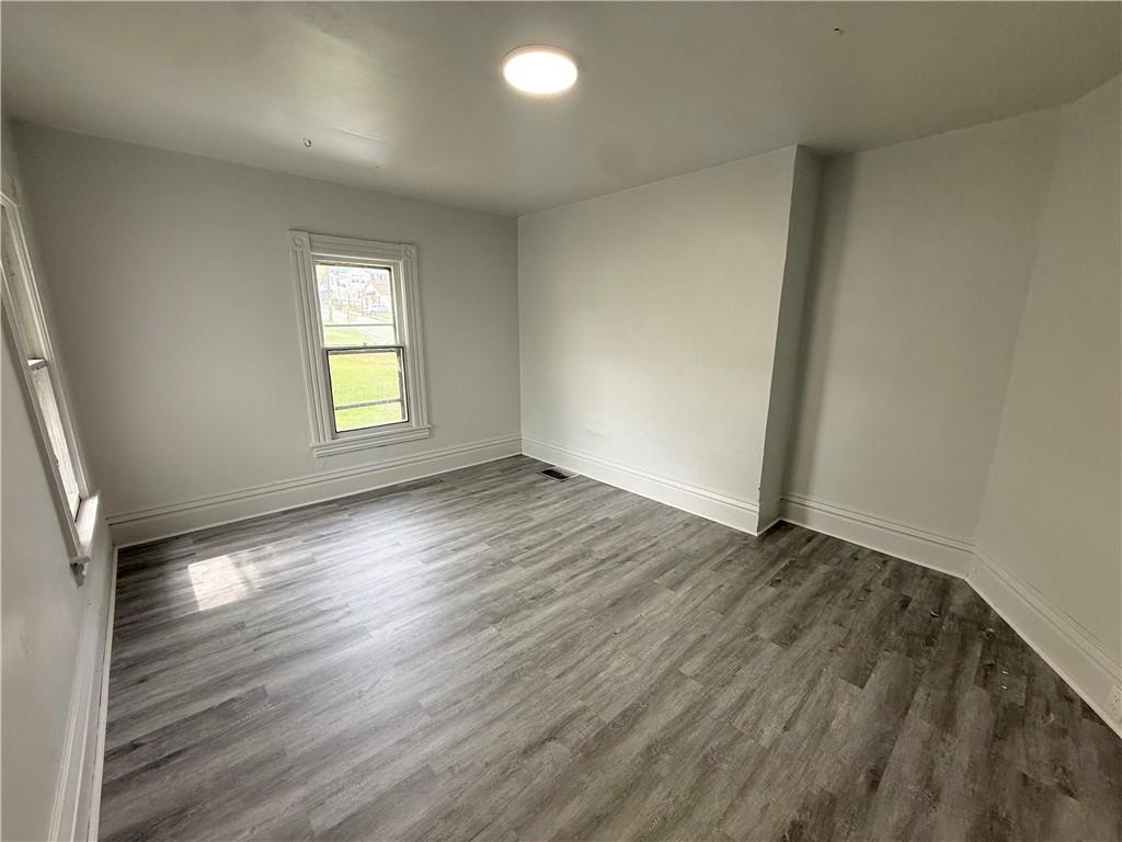 307 Andrew Street Sharon, PA 16146 - Photo 7 of 7 an empty room with wooden floor and windows