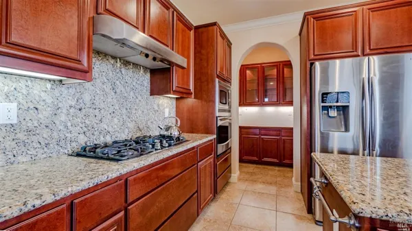 a kitchen with stainless steel appliances granite countertop a stove and a refrigerator