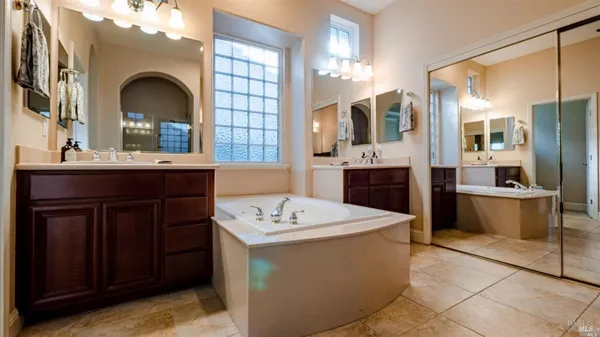 a dining hall with granite countertop a sink stove and cabinets