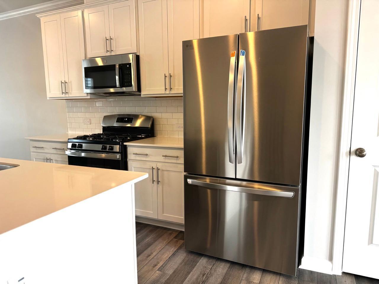 168 Aster Bloom Lane Raleigh, NC 27610 - Photo 12 of 38 a kitchen with stainless steel appliances granite countertop a refrigerator a stove top oven a sink and dishwasher