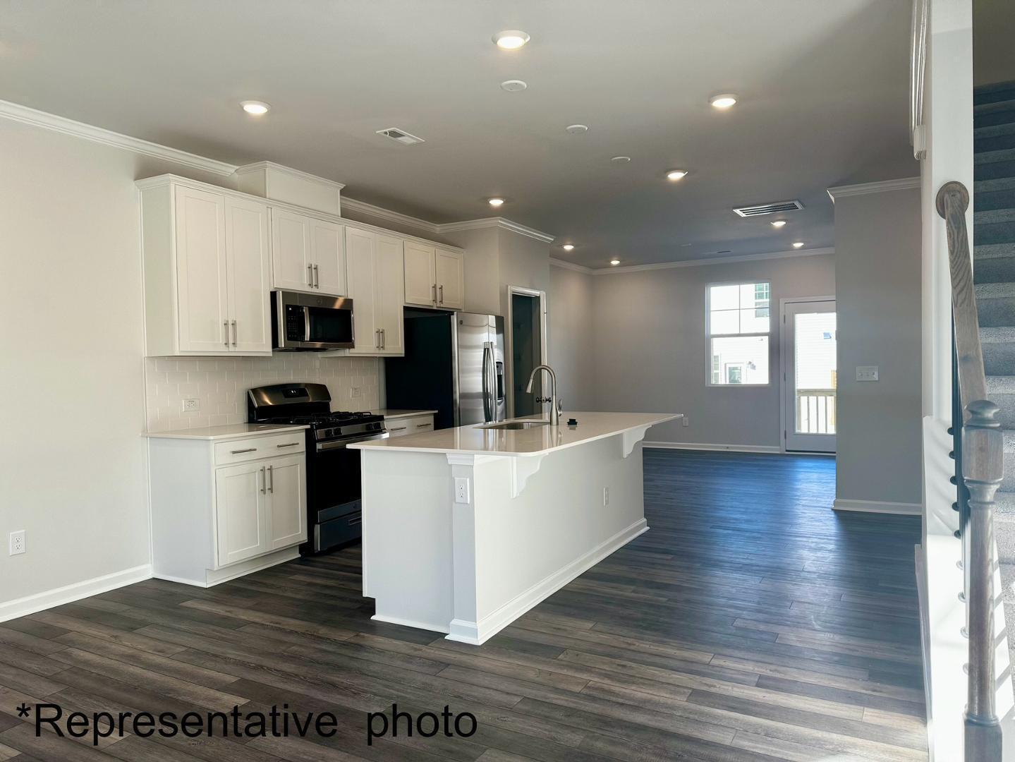 168 Aster Bloom Lane Raleigh, NC 27610 - Photo 13 of 38 a view of kitchen with microwave and cabinets