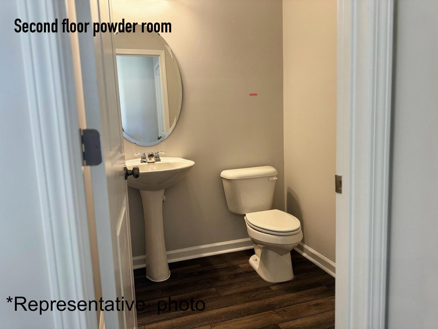 168 Aster Bloom Lane Raleigh, NC 27610 - Photo 17 of 38 a white toilet sitting next to a bathroom sink