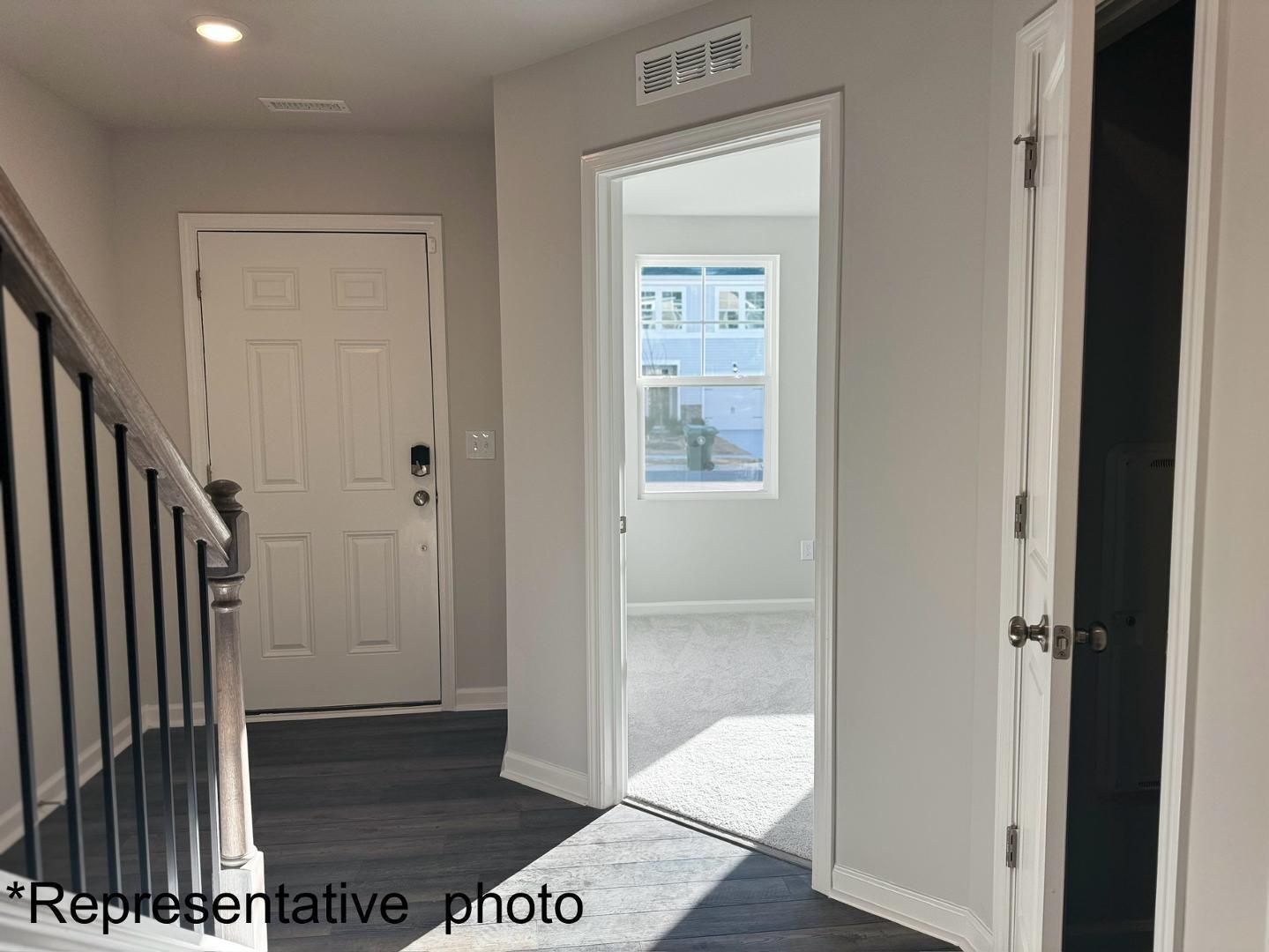 168 Aster Bloom Lane Raleigh, NC 27610 - Photo 5 of 38 a view of a hallway with wooden floor and a livingroom