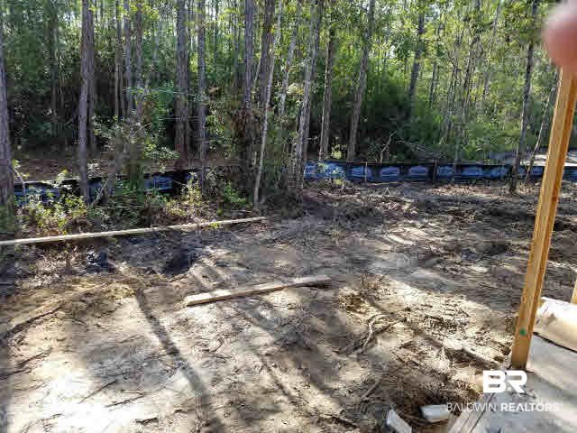5628 Millhouse Road Gulf Shores, AL 36542 - Photo 12 of 12 Plenty of space for a potential pool off patio--great outdoor space including wood privacy in back. Awesome lot!