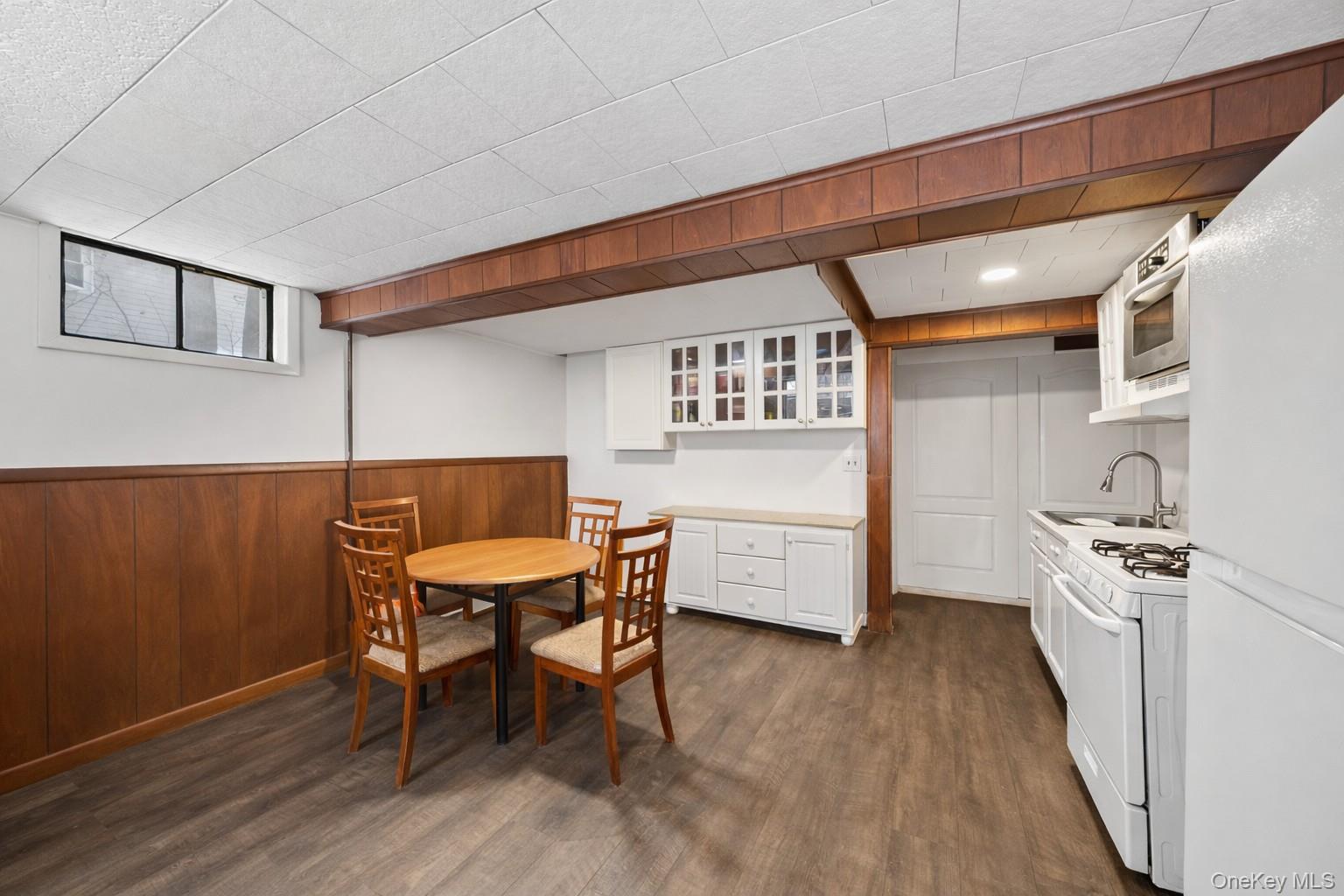 15 Bridge Street Suffern, NY 10901 - Photo 14 of 22 a kitchen with a table chairs a sink dishwasher stove and cabinets with wooden floor