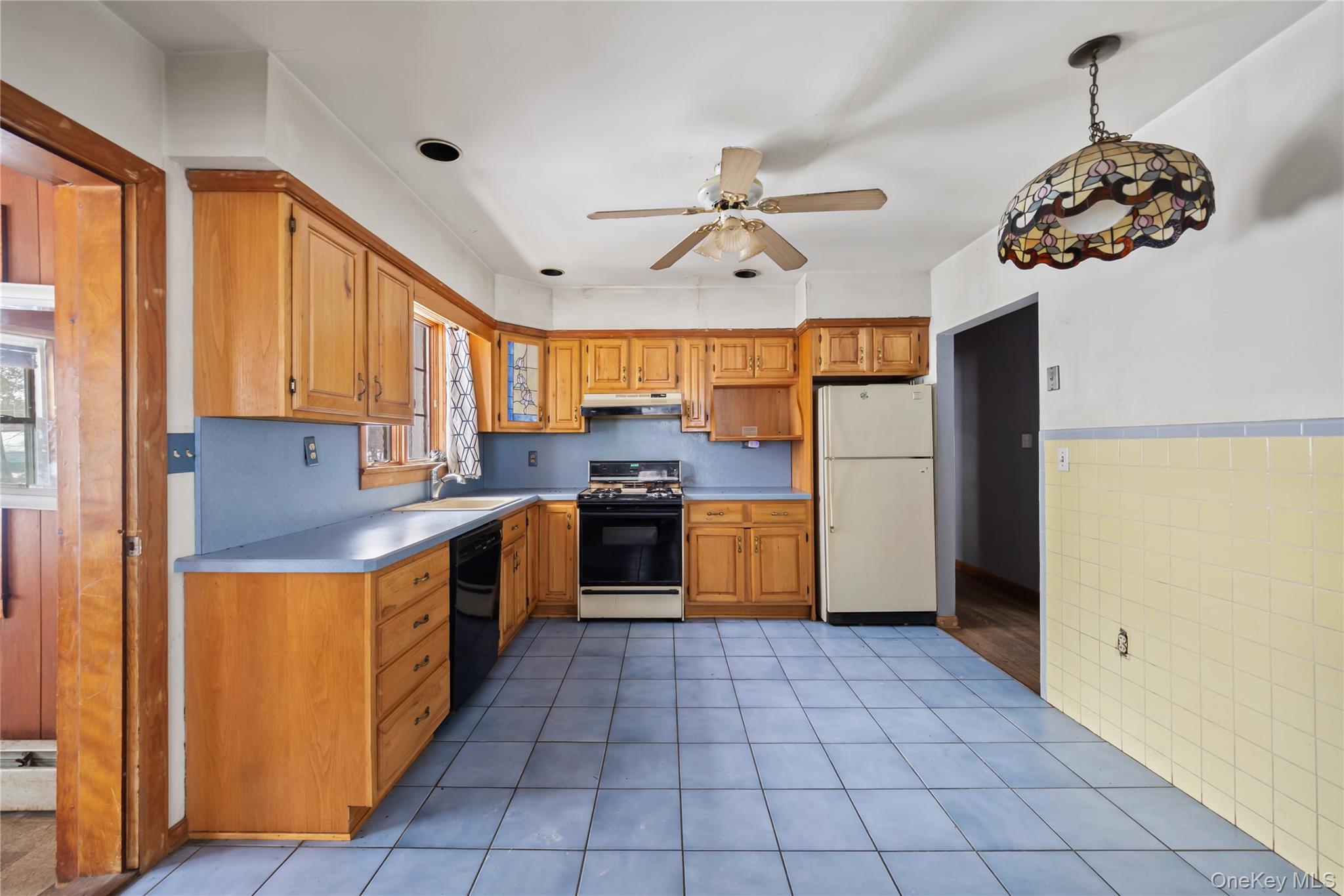 15 Bridge Street Suffern, NY 10901 - Photo 7 of 22 a kitchen with a stove a sink and a refrigerator