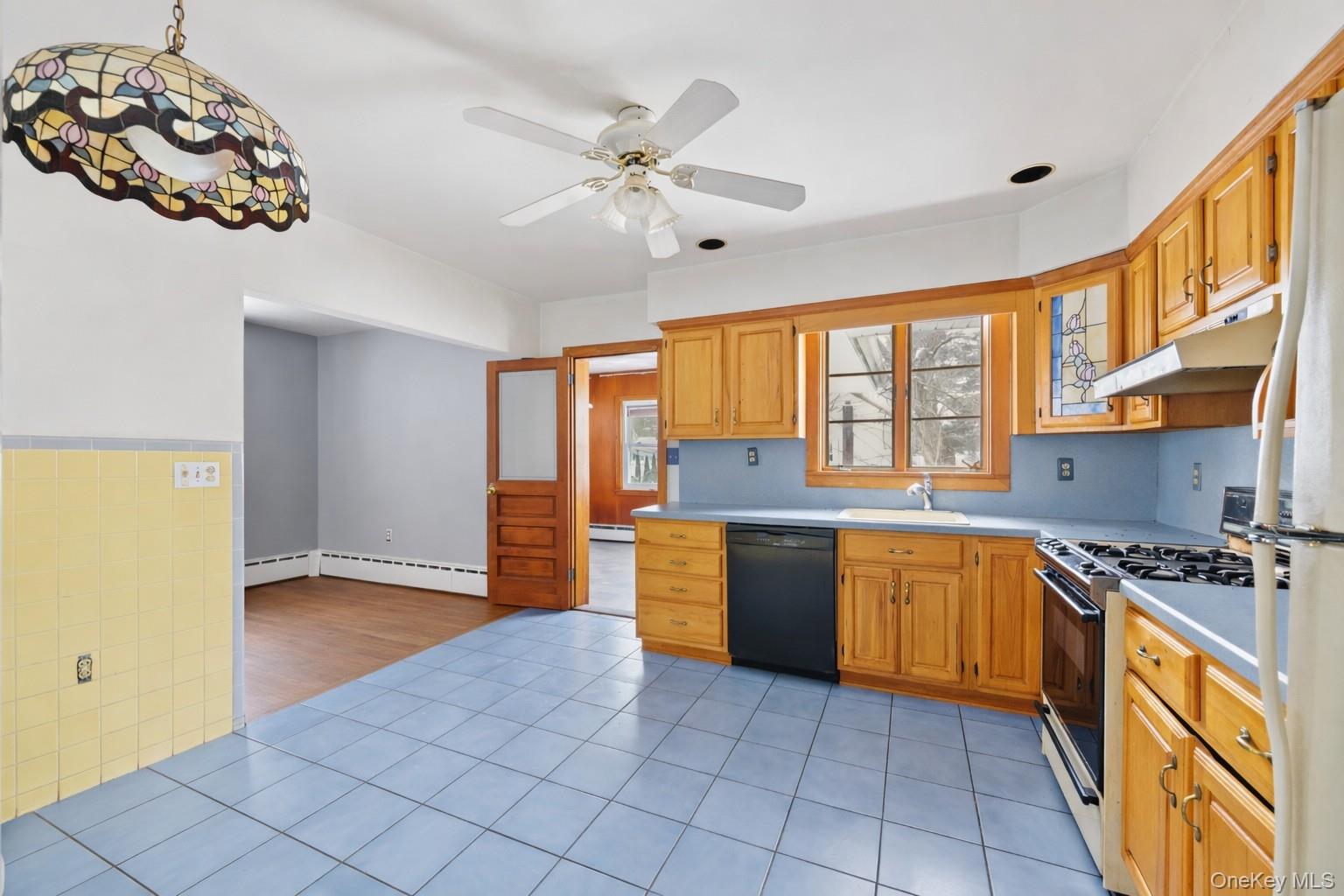 15 Bridge Street Suffern, NY 10901 - Photo 8 of 22 a large kitchen with stainless steel appliances granite countertop a stove a sink and a refrigerator