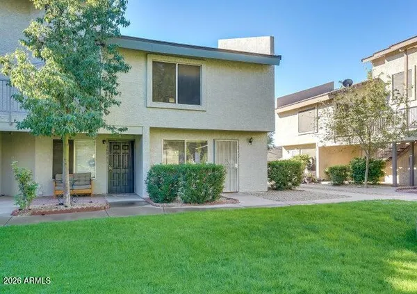 a front view of a house with a yard and outdoor seating