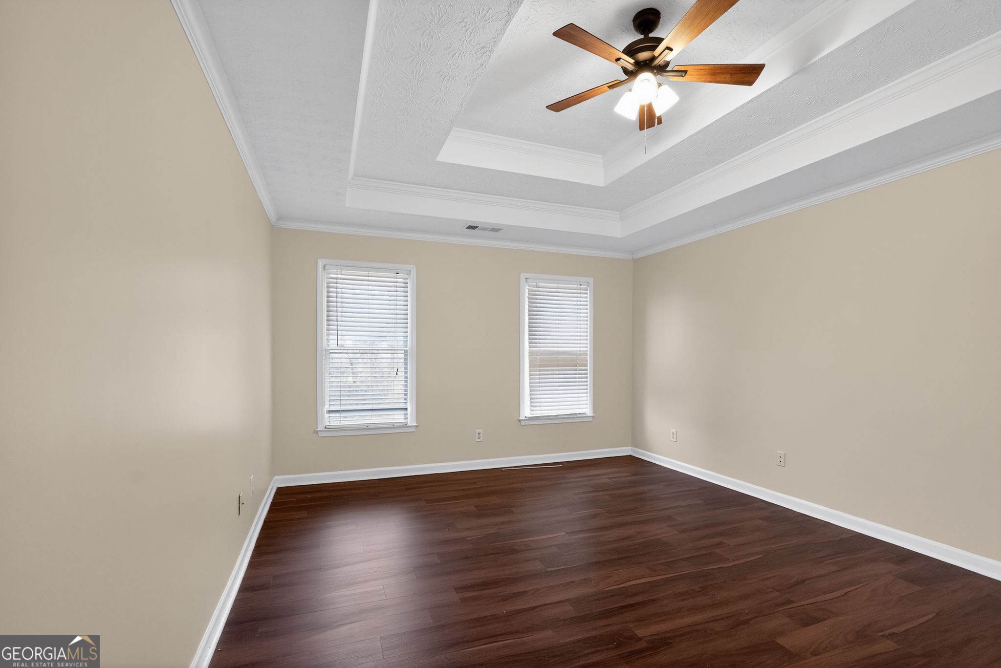 3960 East Saddle Ridge Drive Lithonia, GA 30038 - Photo 11 of 36 an empty room with wooden floor fan and windows