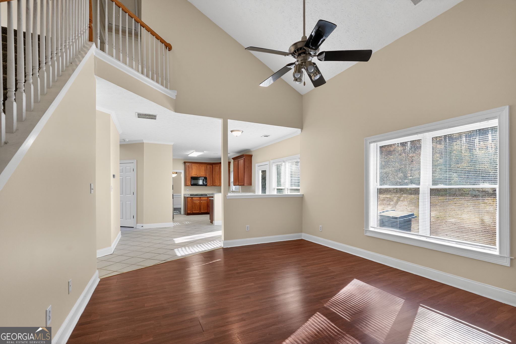 3960 East Saddle Ridge Drive Lithonia, GA 30038 - Photo 13 of 36 a view of a livingroom with wooden floor and a ceiling fan