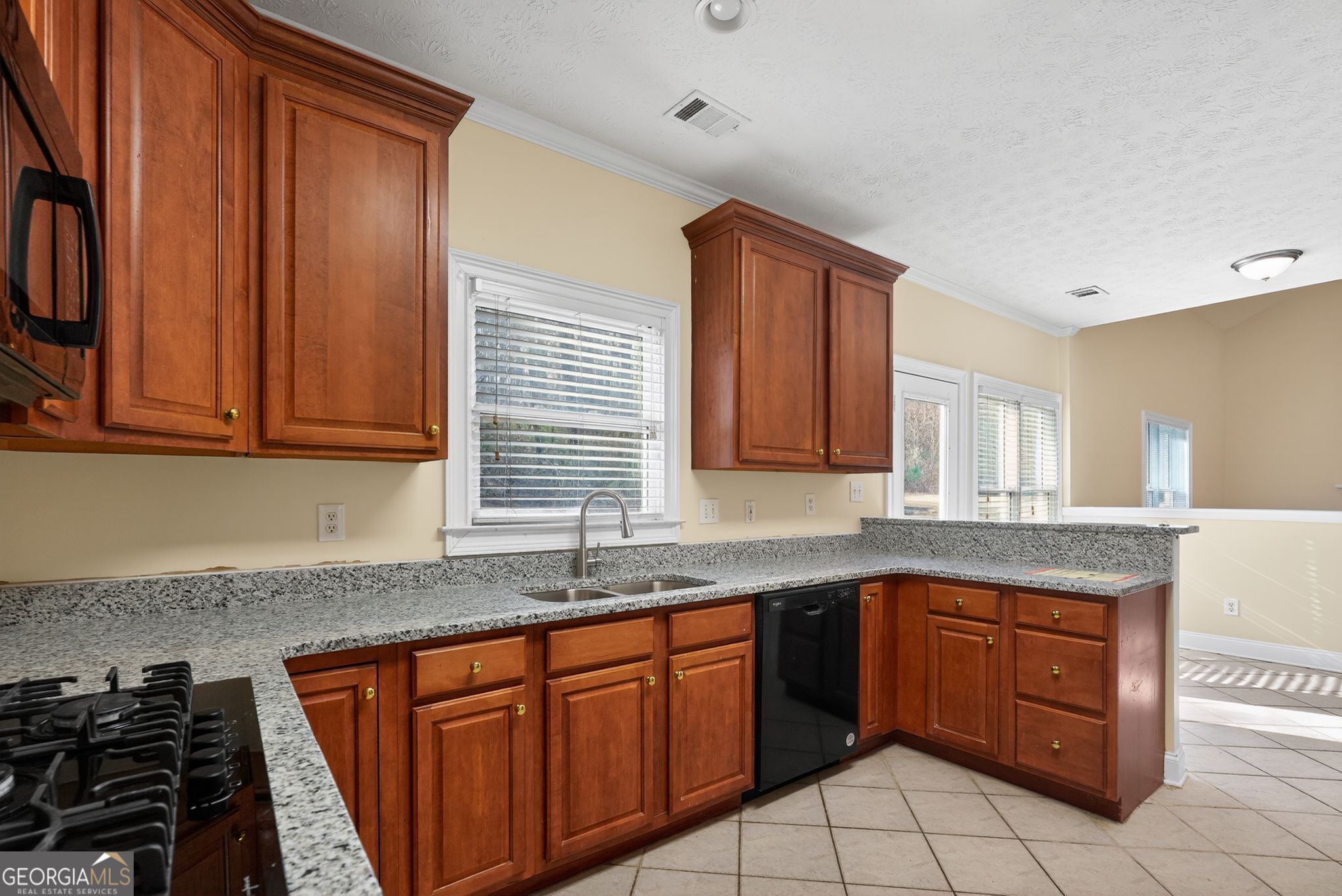 3960 East Saddle Ridge Drive Lithonia, GA 30038 - Photo 16 of 36 a kitchen with stainless steel appliances granite countertop a sink stove and cabinets