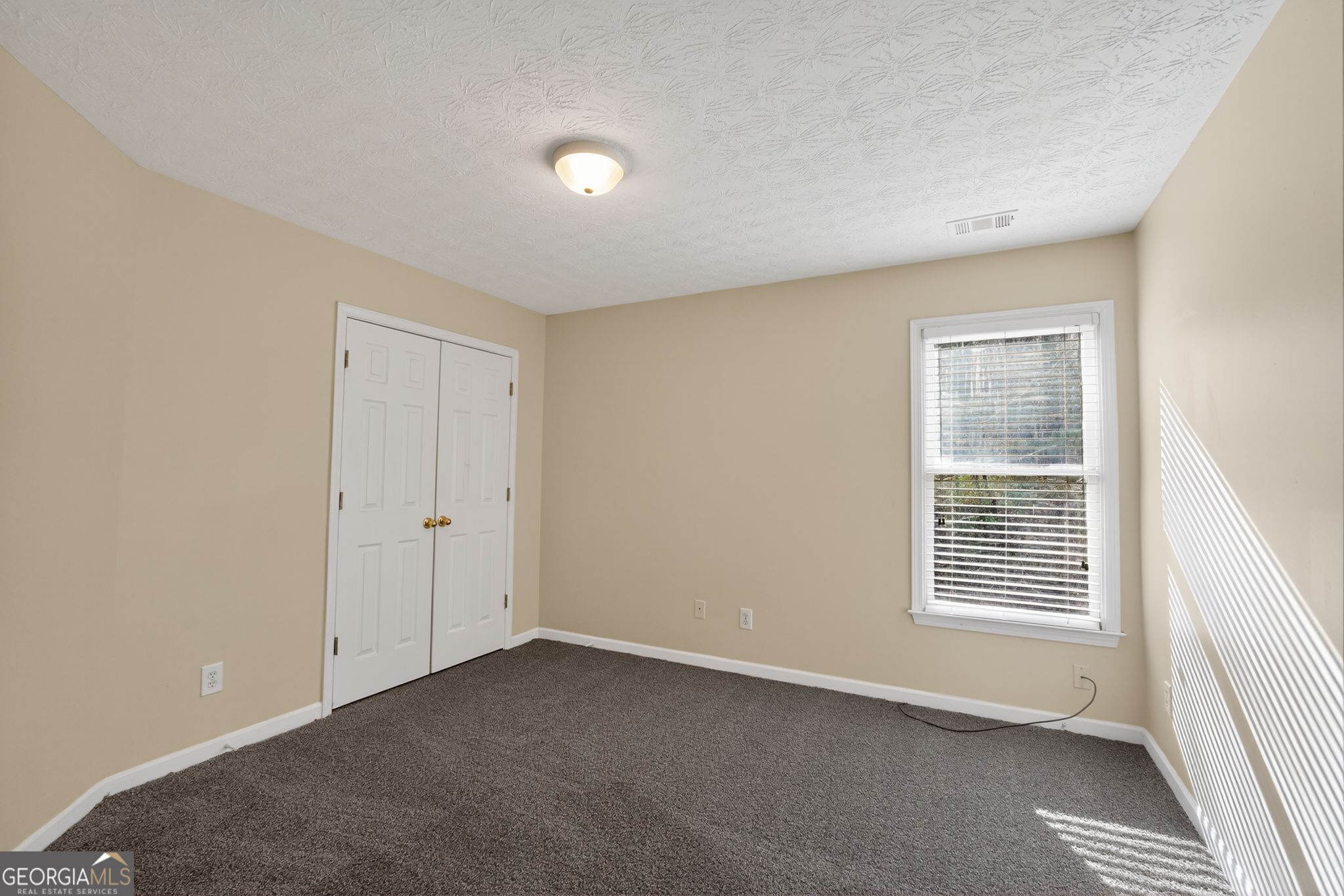 3960 East Saddle Ridge Drive Lithonia, GA 30038 - Photo 18 of 36 a view of an empty room with a window