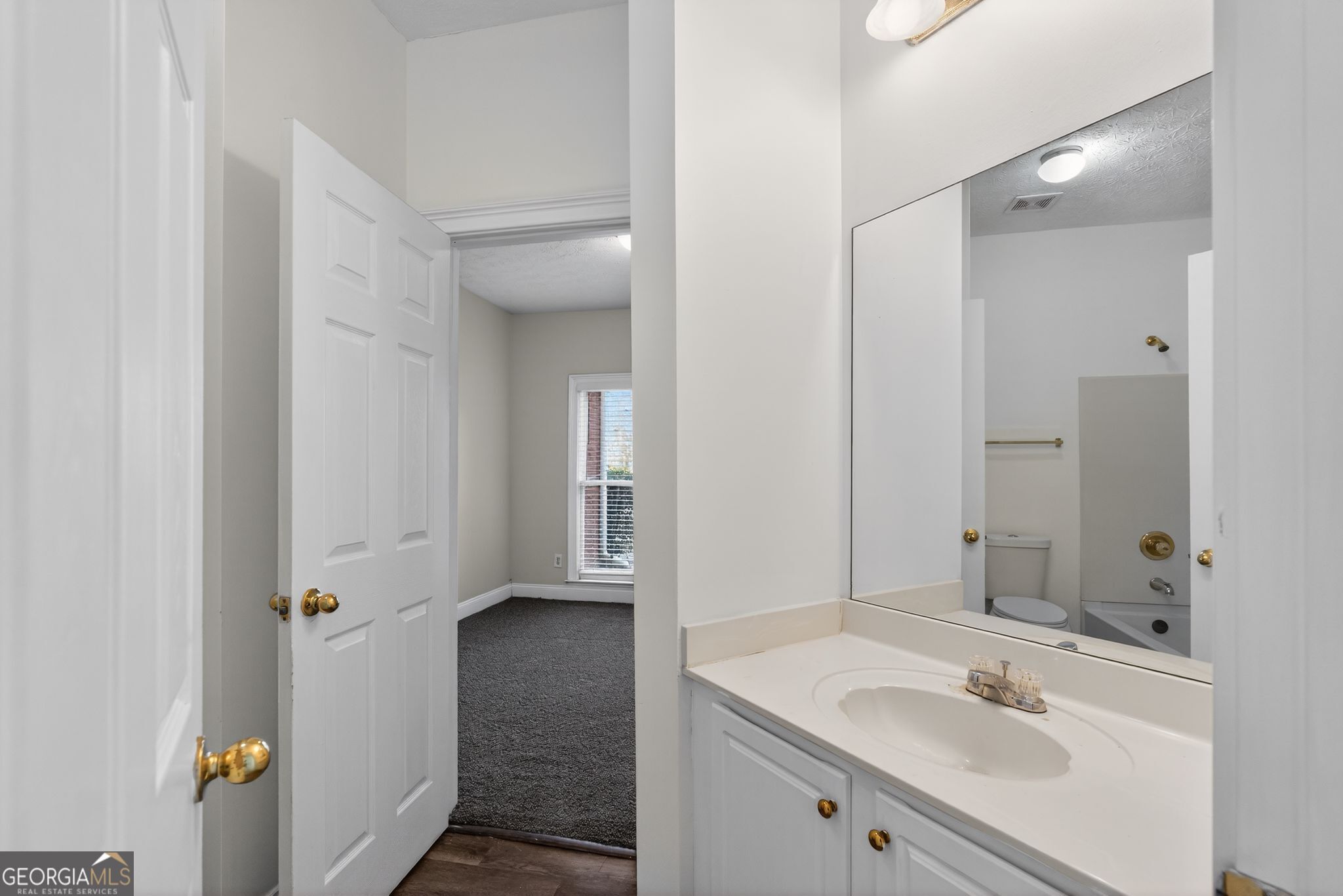 3960 East Saddle Ridge Drive Lithonia, GA 30038 - Photo 21 of 36 a bathroom with a sink and mirror