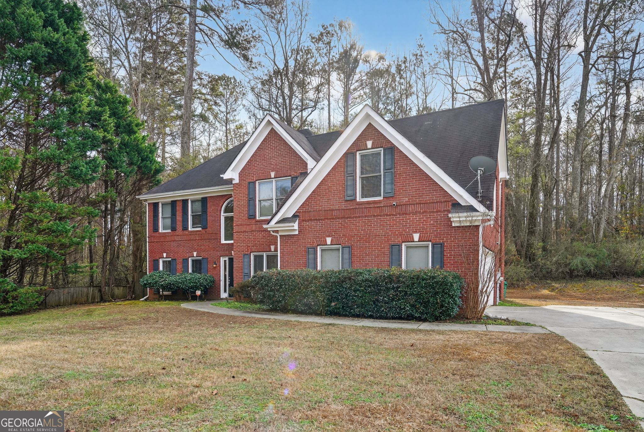 3960 East Saddle Ridge Drive Lithonia, GA 30038 - Photo 3 of 36 a front view of a house with a yard and trees