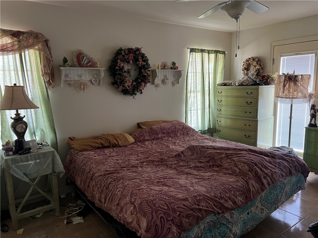 4493 Highway 359 Benavides, TX 78341 - Photo 7 of 20 a bed sitting in a bedroom next to a window