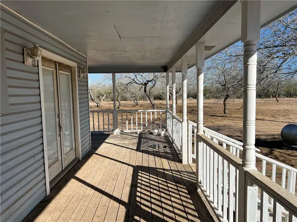 a view of a balcony with wooden floor