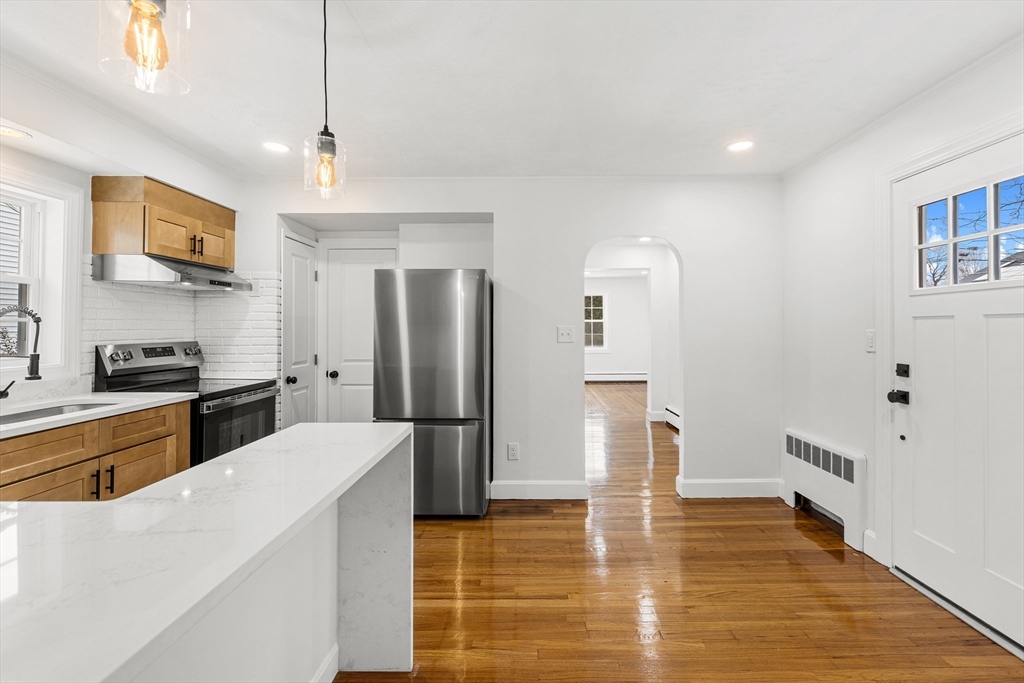 225 Rich Street Fall River, MA 02720 - Photo 11 of 30 a kitchen with stainless steel appliances a refrigerator and a stove top oven