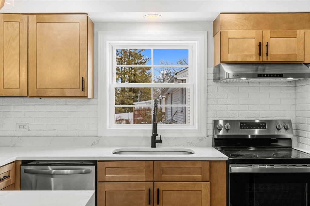 225 Rich Street Fall River, MA 02720 - Photo 12 of 30 a kitchen with stainless steel appliances granite countertop a sink stove and cabinets