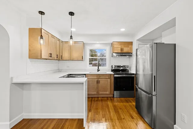 a kitchen that has a sink and a stove in it