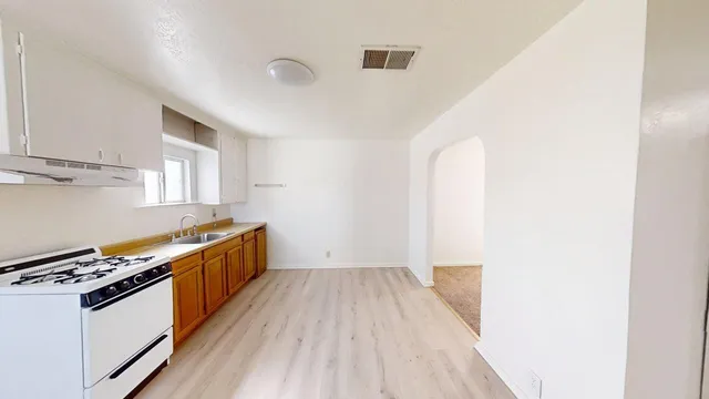 a kitchen with wooden floors and a stove