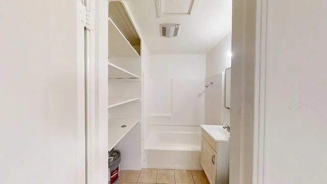 a bathroom with a tub and shower