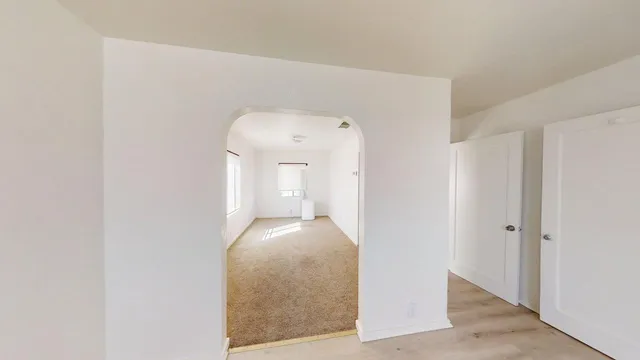 a view of hallway with wooden floor