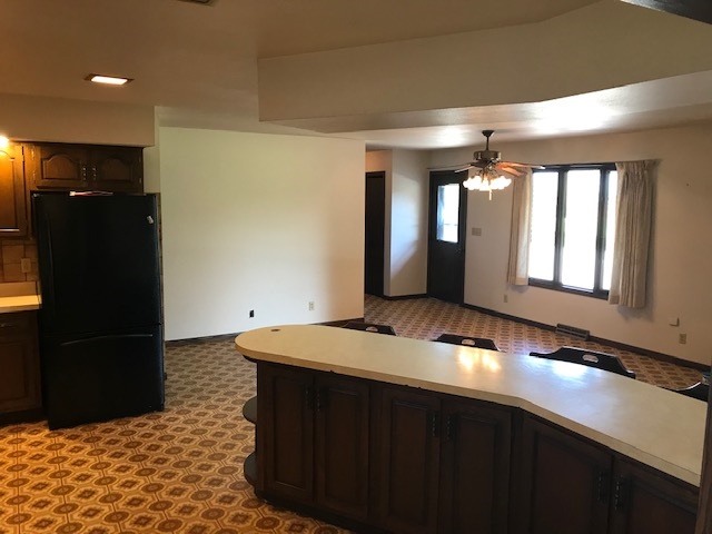 2983 East Water Road Byron, IL 61010 - Photo 3 of 17 a kitchen with a sink and a refrigerator
