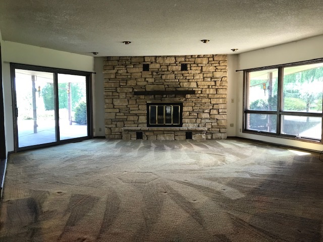 2983 East Water Road Byron, IL 61010 - Photo 5 of 17 a view of empty room with a fireplace