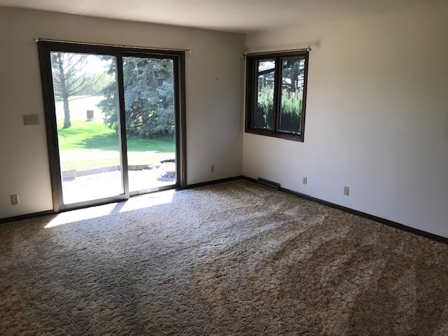 2983 East Water Road Byron, IL 61010 - Photo 8 of 17 an empty room with large windows