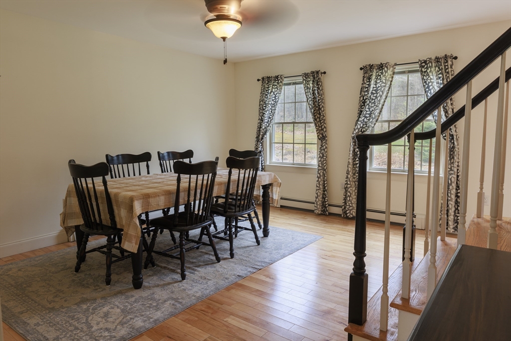 501 Reservoir Road Deering, NH 03244 - Photo 11 of 40 a view of a dining room with furniture window and wooden floor