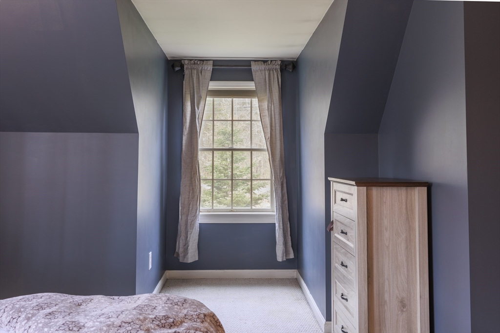 501 Reservoir Road Deering, NH 03244 - Photo 23 of 40 a bedroom with a bed and a window
