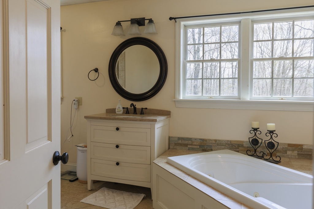 501 Reservoir Road Deering, NH 03244 - Photo 25 of 40 a bathroom with a sink and a bathtub