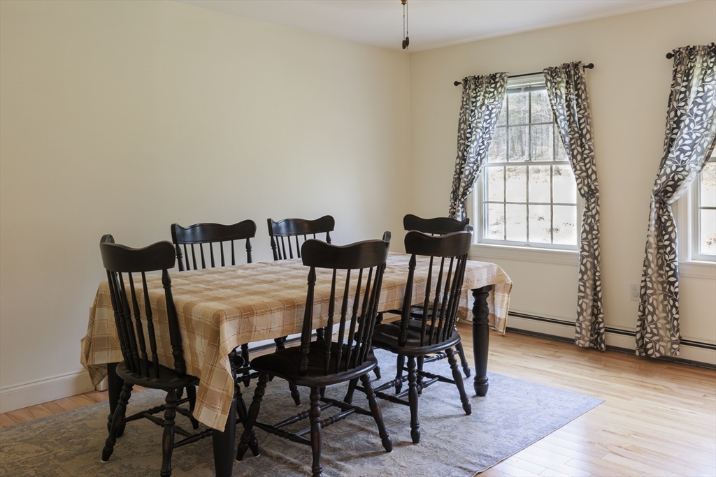 501 Reservoir Road Deering, NH 03244 - Photo 10 of 40 a view of a dining room with furniture and wooden floor