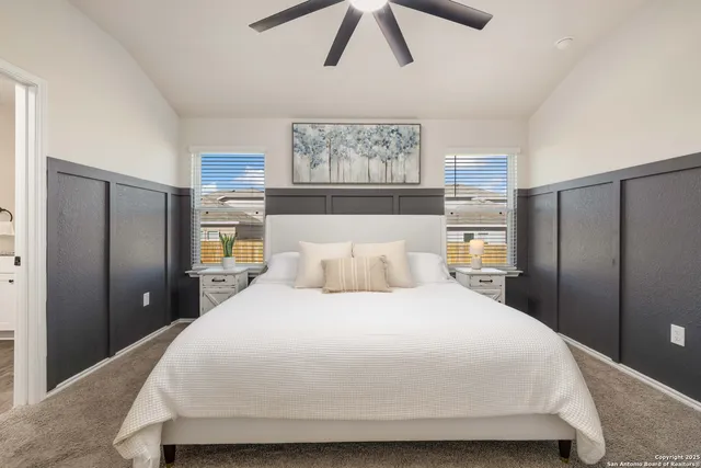 a bedroom with a large bed and a large window