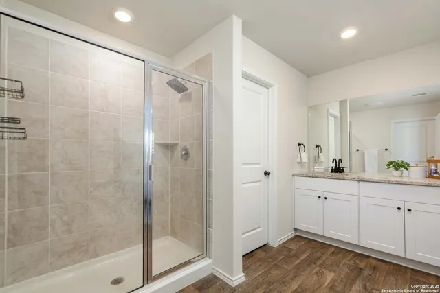 a bathroom with a shower and a sink