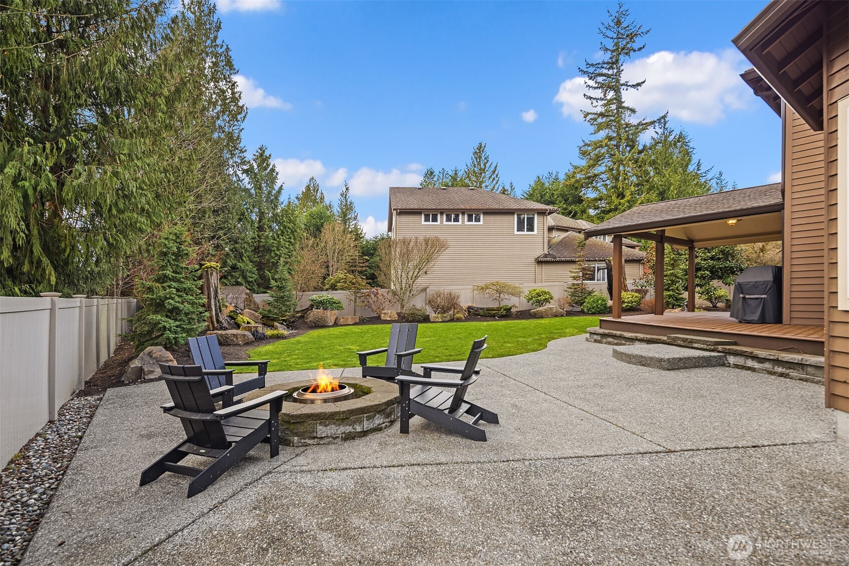 2730 187th Street Southeast Bothell, WA 98012 - Photo 31 of 38 a view of a chair and table in front of a house