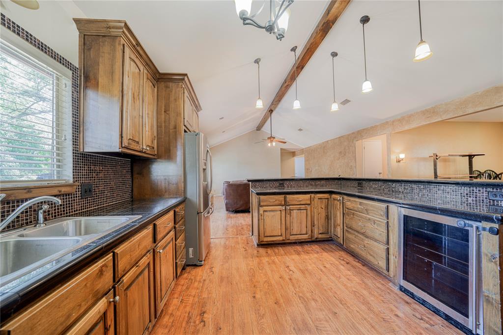 1006 Rikkity Lane Mount Pleasant, TX 75455 - Photo 12 of 39 a kitchen with stainless steel appliances granite countertop a sink a stove and a wooden floors
