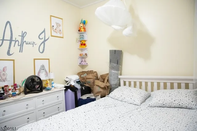 a bedroom with bed and cabinets