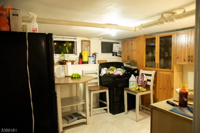 a kitchen with stainless steel appliances kitchen island granite countertop a refrigerator and a stove top oven