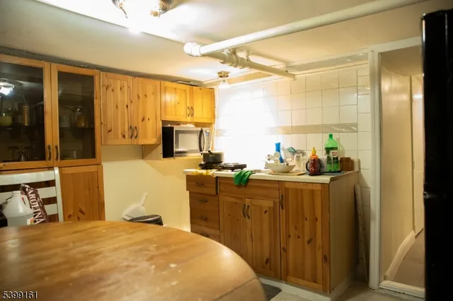 a bedroom with a bed and a view of kitchen