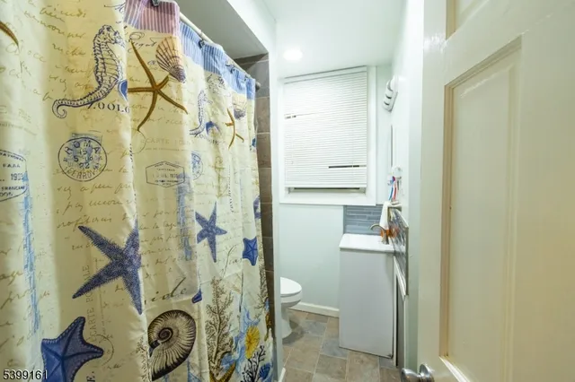 a bathroom with a shower and a toilet