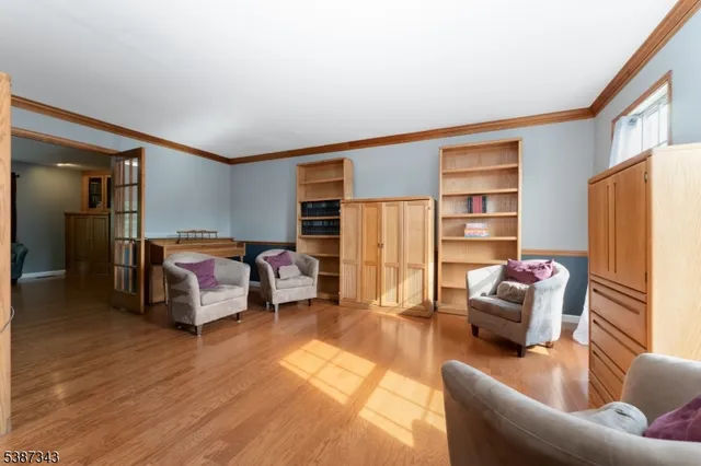 a bedroom with furniture and wooden floor