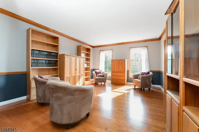 a living room with furniture window and wooden floor