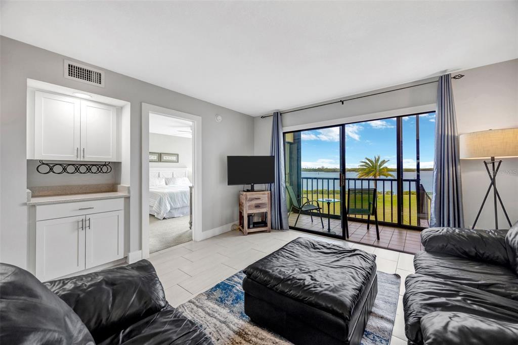4620 Bay Boulevard, Unit 1117 Port Richey, FL 34668 - Photo 18 of 37 a bedroom with a bed and large windows